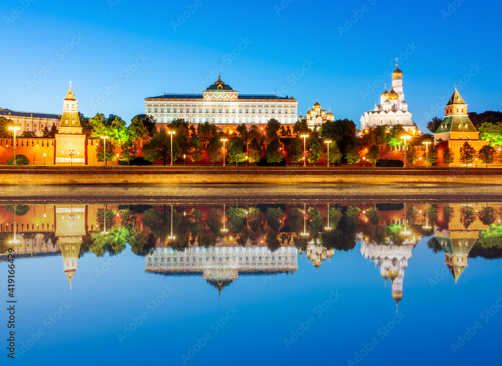 Fototapeta premium Moscow Kremlin with cathedrals, towers and palaces at sunset reflected in Moskva river, Russia