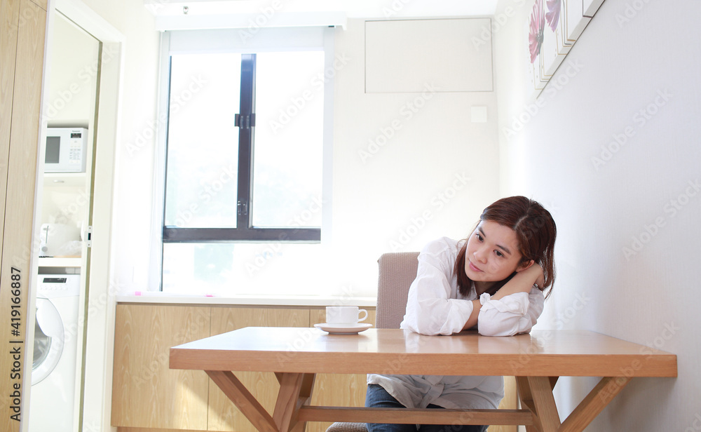 asian wife sit near the table and waiting asian wife sit near the table and waiting