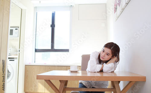 asian wife sit near the table and waiting © LT
