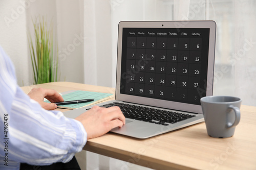 Woman with laptop using cal...