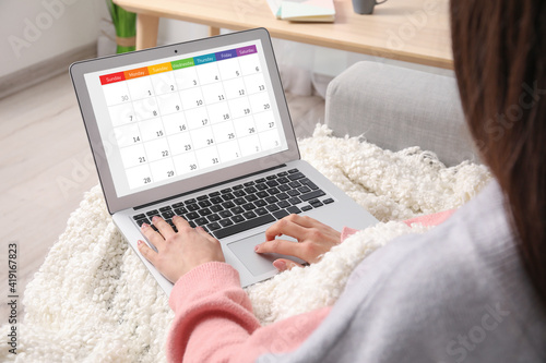 Woman with laptop using cal...