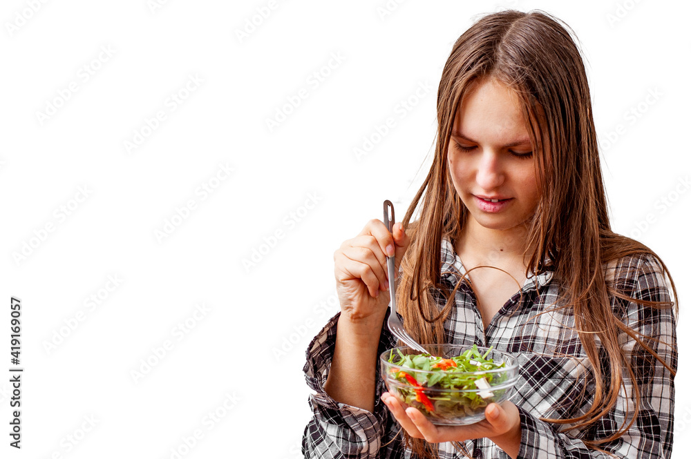 portrait of young teenager brunette girl with long hair eating green vegetables salad isolated on white background portrait of young teenager brunette girl with long hair eating green vegetables salad isolated on white background
