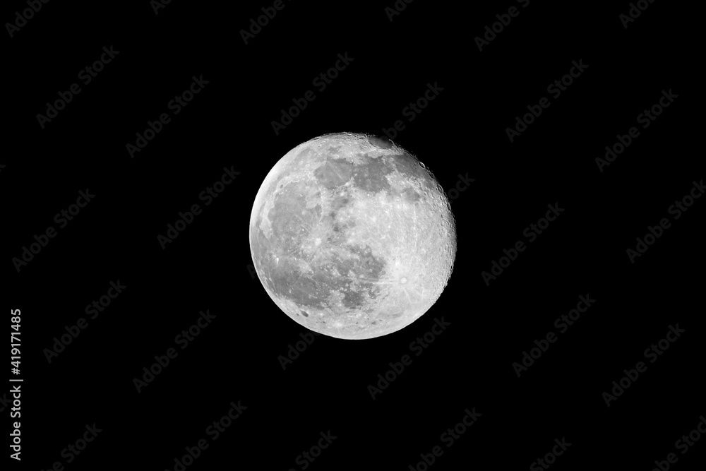 Full lunar moon isolated in the clear night sky Full lunar moon isolated in the clear night sky