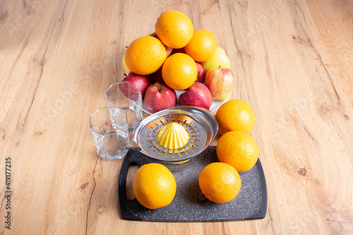 Manual juicer and fruits: oranges, apples. Healthy drinks