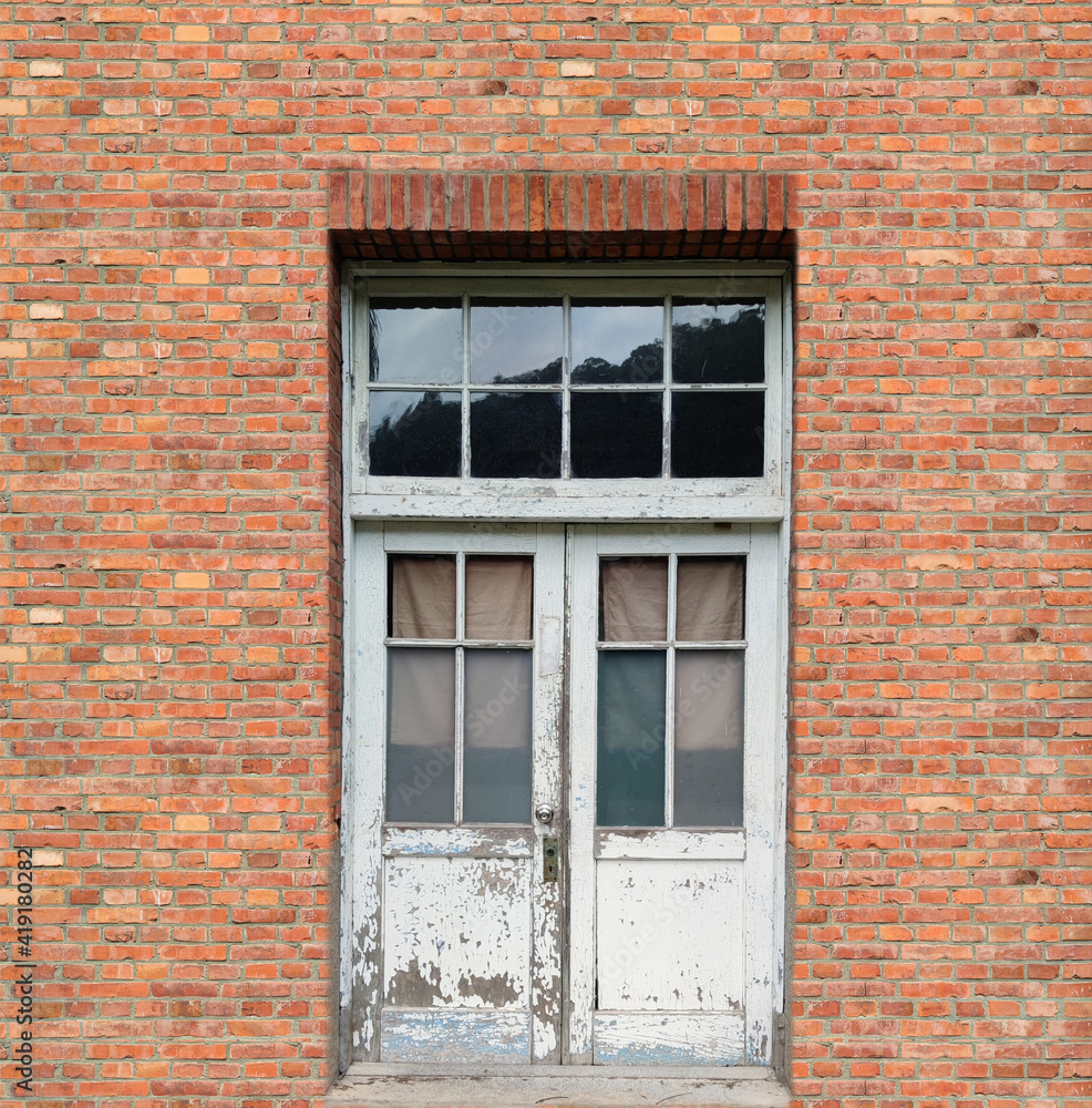 White window at vintage red brick wall
