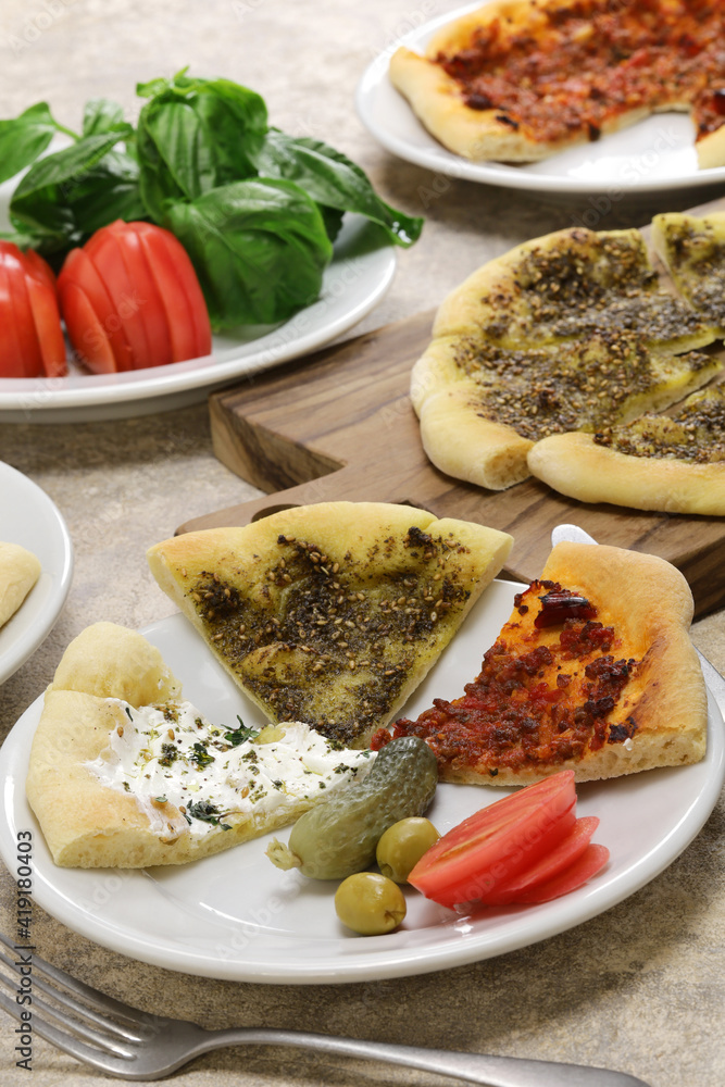 manakeesh, lebantine pizza, topping with zaatar(thyme), labneh(strained yogurt) and groud beef