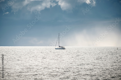 boat sailing in the sea under similar clouds