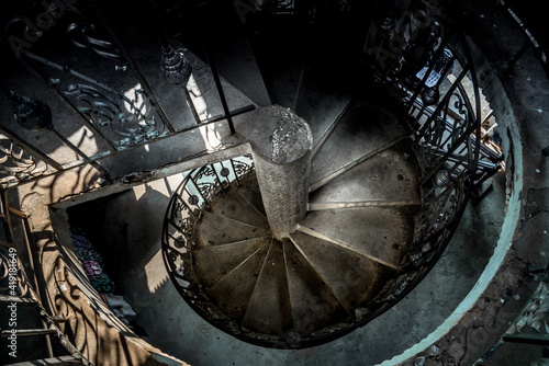 An ornate spiral staircase in asia. Old and dilapidated this blue stone staircase has a ton of character photo