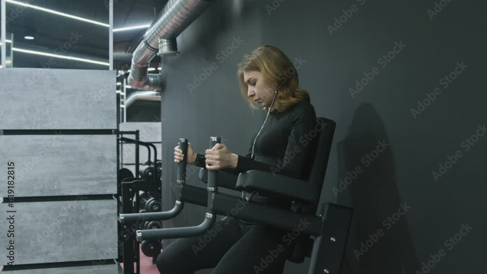 Young Attractive Fitness Woman witn headphones finished her exercise and leaves Young Attractive Fitness Woman witn headphones finished her exercise and leaves