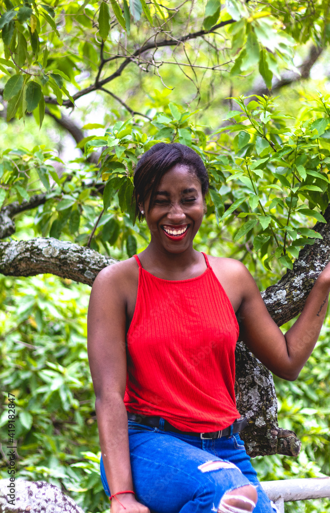 Young African American woman wearing a red blouse. In the city of Cali Valle del Cauca Colombia. Young African American woman wearing a red blouse. In the city of Cali Valle del Cauca Colombia.