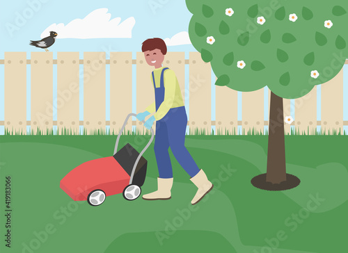 Young man cutting grass in his garden with grass cutter. lawnmower