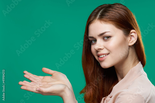 cheerful woman gesturing with her hands emotions green background studio