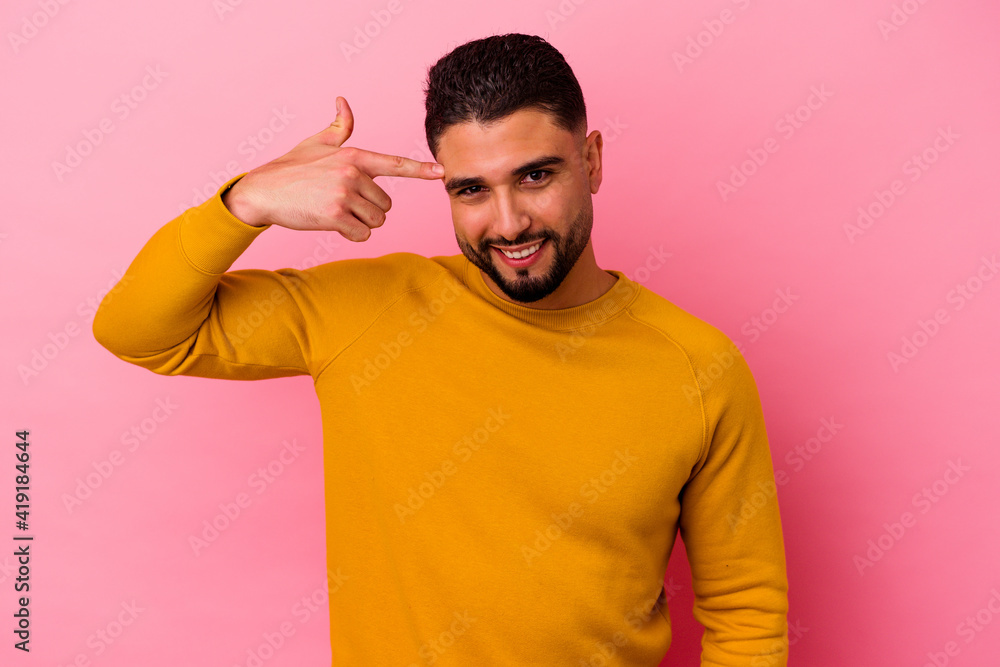 Young mixed race man isolated on pink background Young mixed race man isolated on pink background