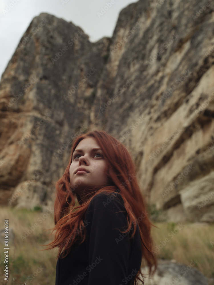 Side view portrait of woman in black dress on nature in mountains Side view portrait of woman in black dress on nature in mountains
