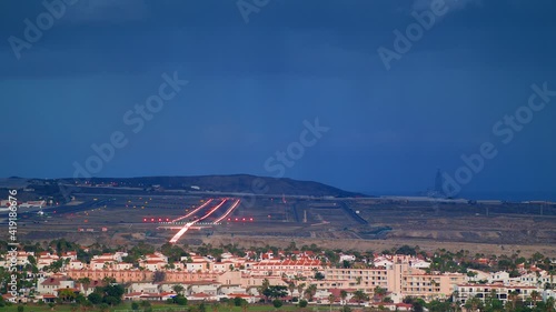 a Passenger plane takes off from the airport from the Runway. Airplane runway in Bad Weather.
a Passenger Plane descends for Landing.
Airport on the island of Tenerife, Spain. photo