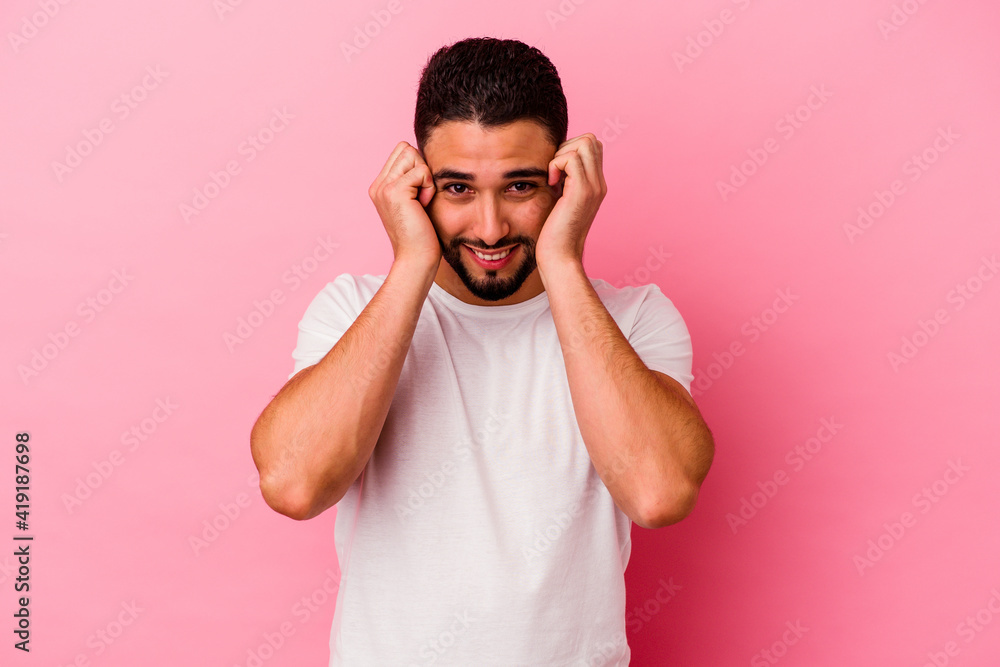Young mixed race man isolated on pink background Young mixed race man isolated on pink background