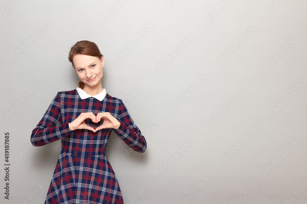 Portrait of happy girl making heart gesture with hands over chest Portrait of happy girl making heart gesture with hands over chest