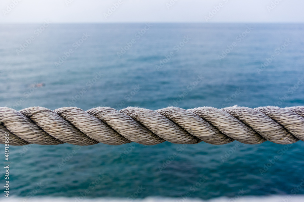 Fototapeta premium old marine rope on the pebble beach