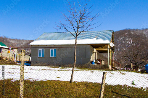 Village old cottage in the snow landscape