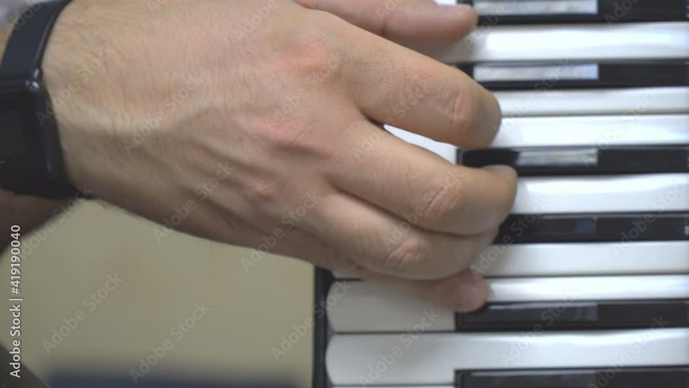 Accordion player's right hand on the accordion keyboard Accordion player's right hand on the accordion keyboard