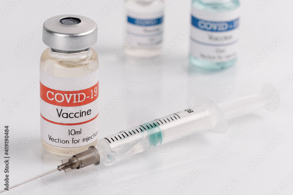 vaccine covid-19 vaccine vials with syringe, on a white background vaccine covid-19 vaccine vials with syringe, on a white background