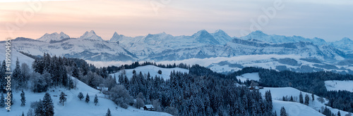 panoramic view on a beautiful winter sunrise in snowy Emmental