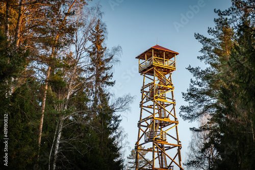 A viewing tower at the Blue Hills of Ogre. Latvia. Watchtower during sunset with trees. photo