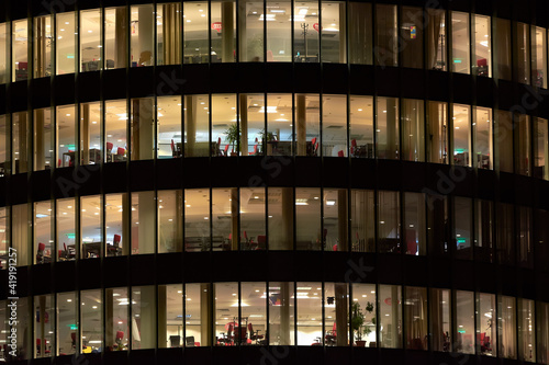 Multi-storey office building at night. Late night at office. Late night overtime in a modern office building