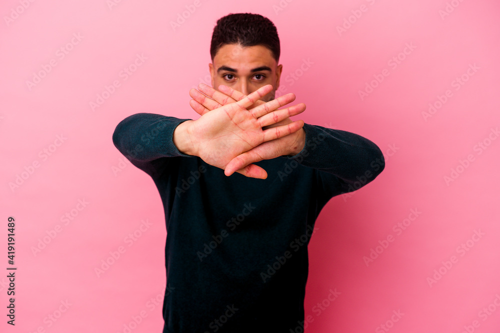 Young mixed race man isolated on pink background Young mixed race man isolated on pink background