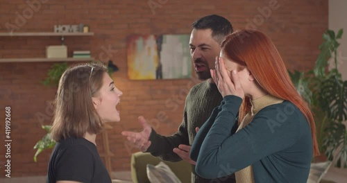 Angry parents arguing with their teenage daughter at home