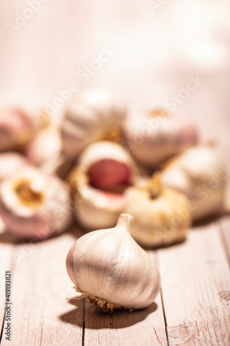 white garlic on wooden table