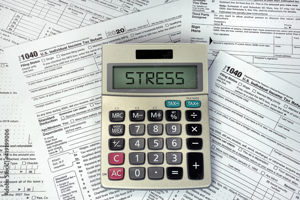 Stress text on business calculator screen with 1040 Internal Revenue Tax Forms Stress text on business calculator screen with 1040 Internal Revenue Tax Forms