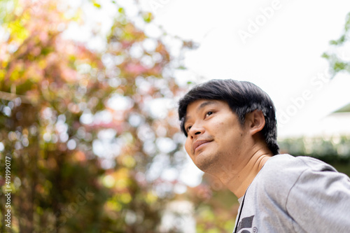 Asian man sightseeing in Autumn foreat enjoy happiness of natural trip in Japan.