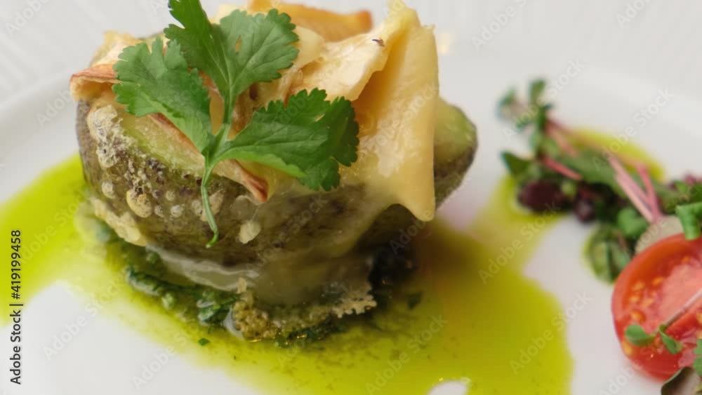 Baked avocado with camembert cheese and cilantro dressing. restaurant dish close-up. Delicious, original, juicy dish. close-up. Baked avocado with camembert cheese and cilantro dressing. restaurant dish close-up. Delicious, original, juicy dish. close-up.
