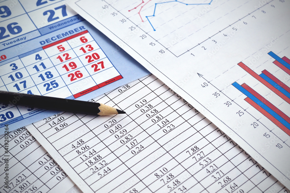 Photos of numbers and graphs with a calendar showing the calculation Photos of numbers and graphs with a calendar showing the calculation