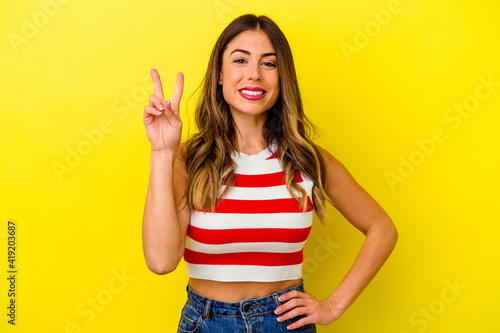 Young caucasian woman isolated on yellow background