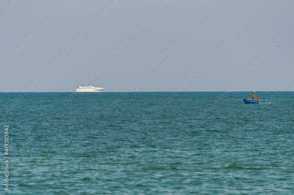 Sea background with ship and small fishing boat
