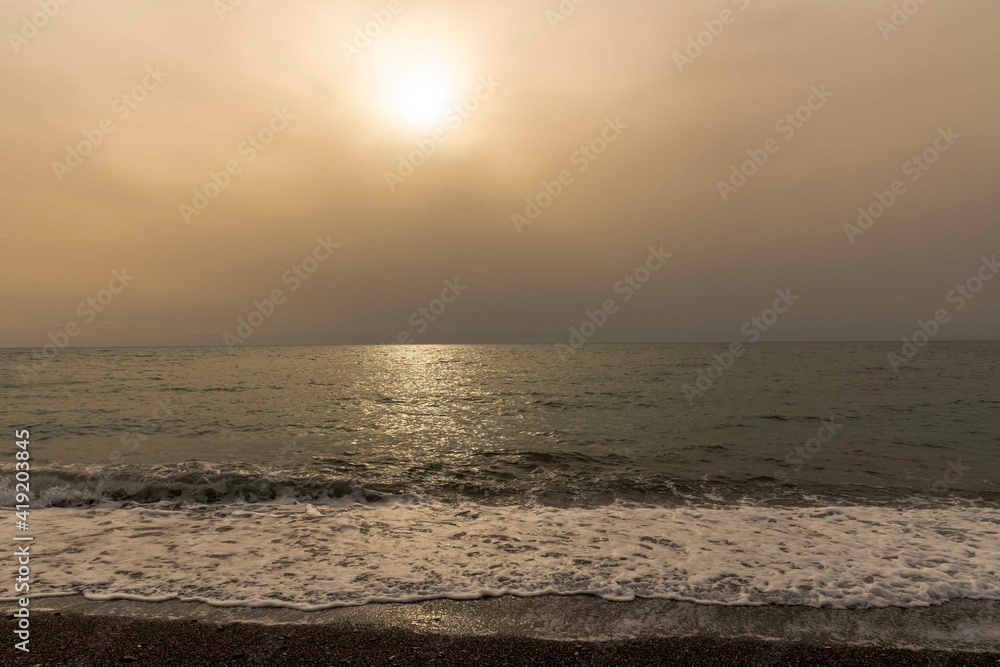 Fototapeta premium Sunset over the sea with haze