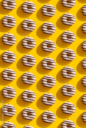 a pattern on a yellow background of donuts photo