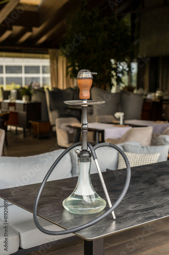 Hookah on the table in the restaurant. vertical photo 