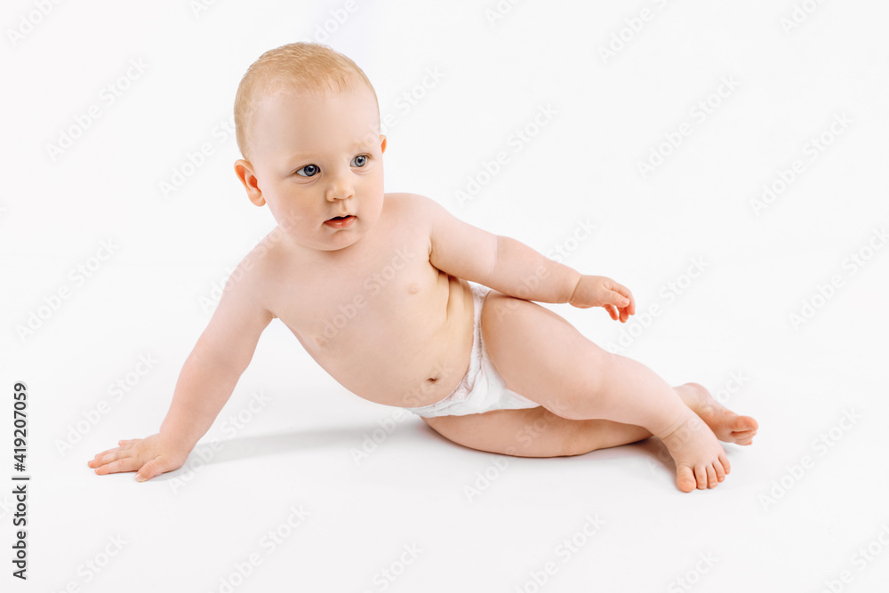 Happy baby in diaper sitting on isolated white background Happy baby in diaper sitting on isolated white background