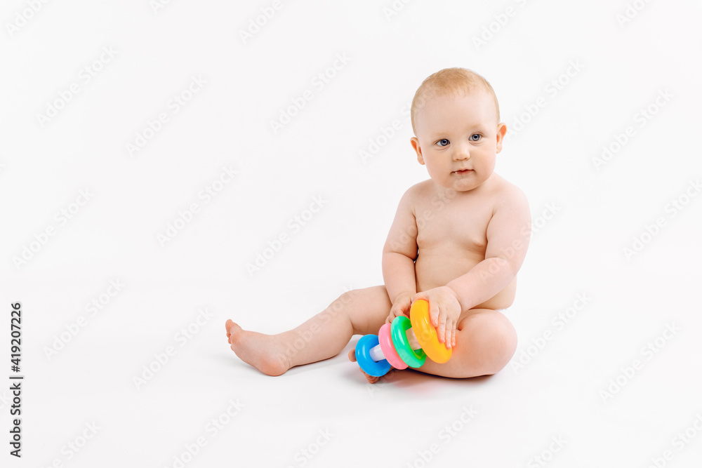 Little kid playing with baby pyramid on white background Little kid playing with baby pyramid on white background