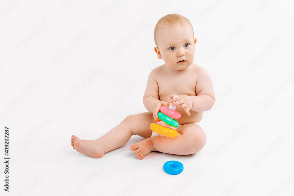 Little kid playing with baby pyramid on white background Little kid playing with baby pyramid on white background