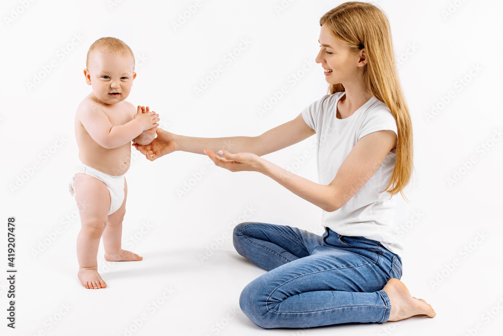 little child learns to walk with the help of the mother, on a white background, little child learns to walk with the help of the mother, on a white background,