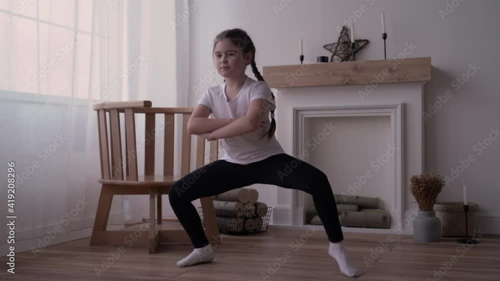 girl child broadcasts an online course and writes a vlog about gymnastics at home. High quality 4k footage girl child broadcasts an online course and writes a vlog about gymnastics at home. High quality 4k footage