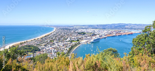 Tauranga, New Zealand. Panoramic view from Mount Maunganui of the white sand beach and City. Tauranga is a major cruise ship destination on northern island of New Zealand photo