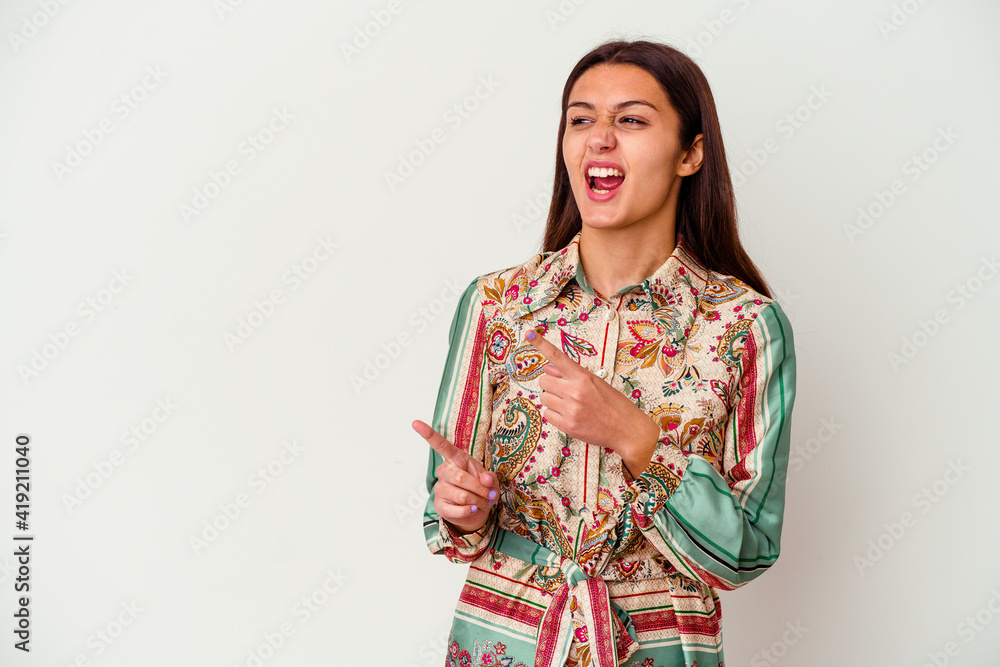 Young Indian woman isolated on white background pointing with forefingers to a copy space, expressing excitement and desire. Young Indian woman isolated on white background pointing with forefingers to a copy space, expressing excitement and desire.