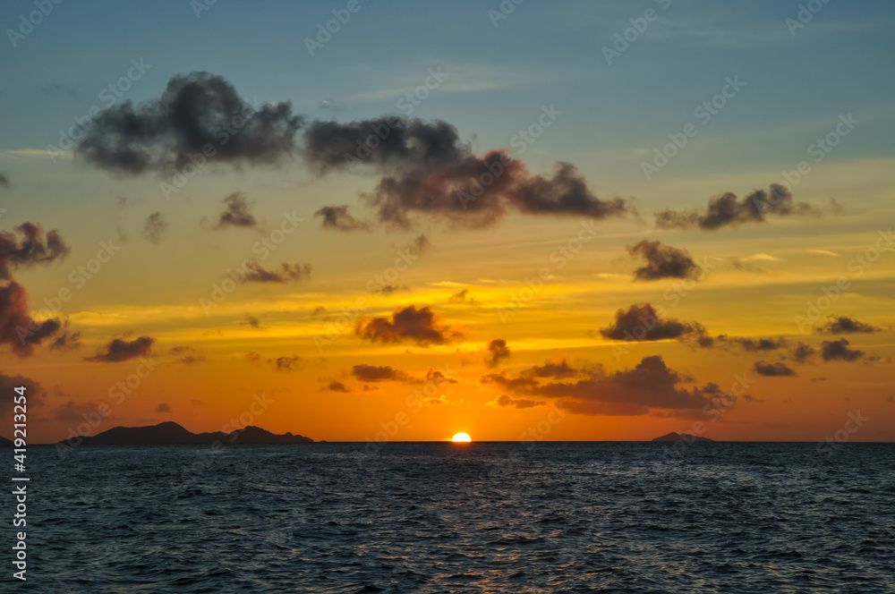 Wonderful Sunset over the sea with island in silhouette
