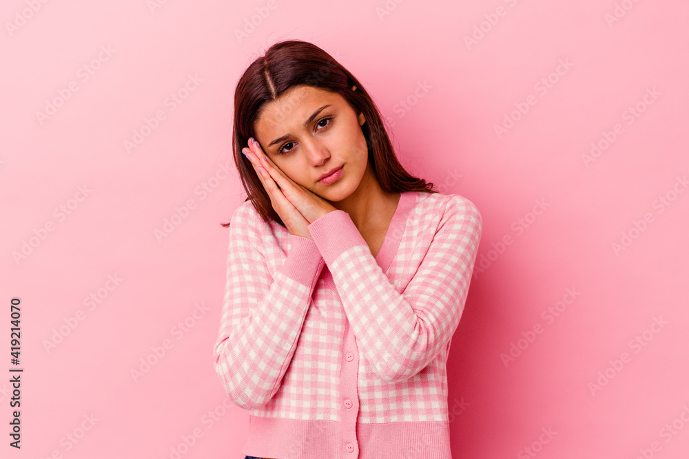 Young Indian woman isolated on pink background yawning showing a tired gesture covering mouth with hand. Young Indian woman isolated on pink background yawning showing a tired gesture covering mouth with hand.