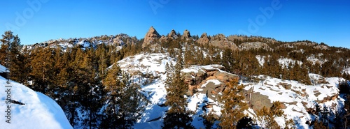 Beautiful panorama landscape snow foerest and hill rock photo